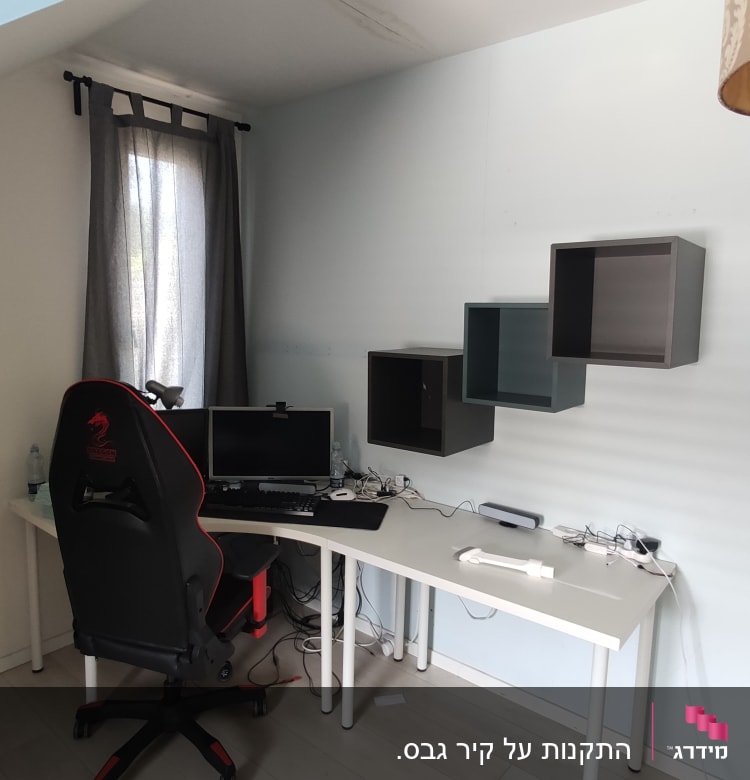 שולחן עבודה עם מחשב, כיסא ומדפים תלויים